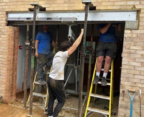 Workmen under door arch